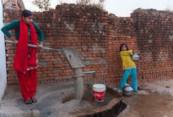 Akhajuraho India Girls Pumping From Water From Communal Pump Akhajuraho India Girls Pumping From Water From Communal Pump