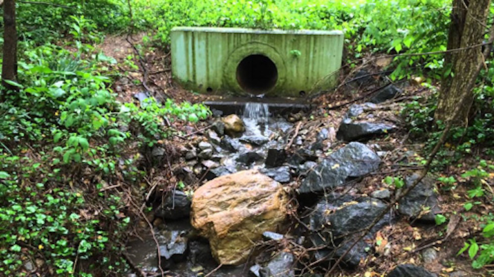 Stormwater runoff draining from a detention pond after a rain storm in Arlington, Virginia.