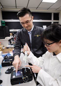 L-R: Assoc Prof Yong Ken-Tye and his PhD student Stephanie Yap, both from the NTU School of Electrical and Electronic Engineering, developed a portable device, inspired by the ability of the human body to detect trace levels of heavy metals in drinking water in just five minutes. Photo Courtesy NTU Singapore.