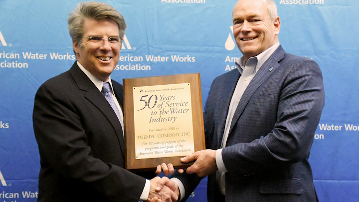 AWWA CEO David LaFrance (left) congratulates Randy Moore, Director of Sales-Agency Development and Industry Affairs and Vice President of the AWWA Board of Directors.
