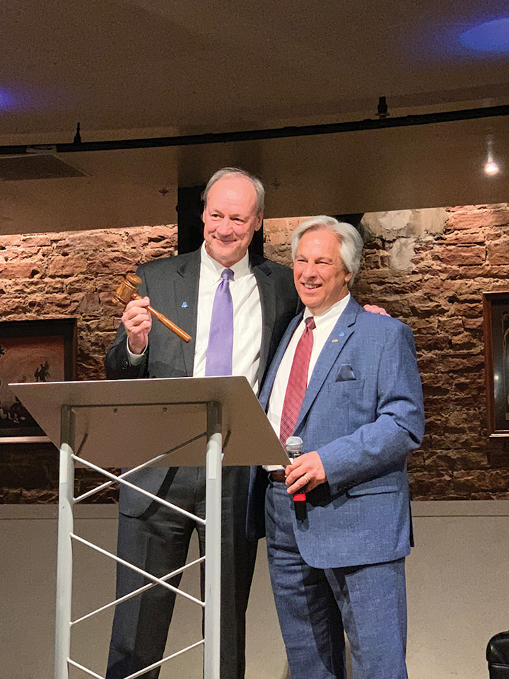 Jim Williams (left) accepts the gavel from David Rager during AWWA’s ACE 2019 conference in Denver. Photo courtesy SUEZ N.A.