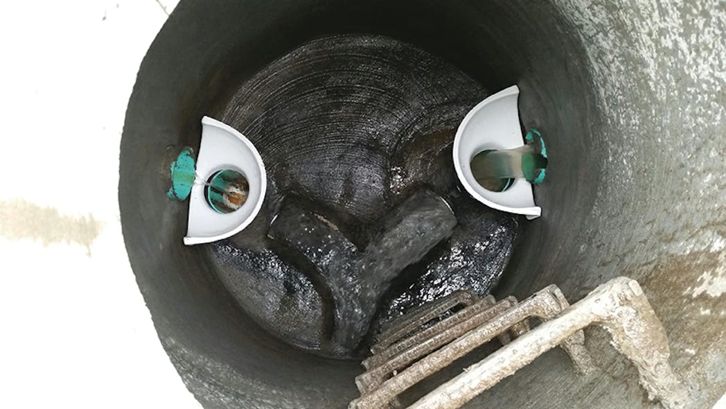 The system consists of a fiberglass drop bowl that is bolted to the manhole wall just beneath the high-level inflow pipe.