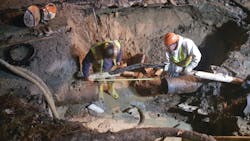 Utility workers addressing a water line break. Utility workers addressing a water line break.