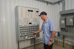 An SCWA production operator on duty at a pump station in Hauppauge, N.Y., inspecting components