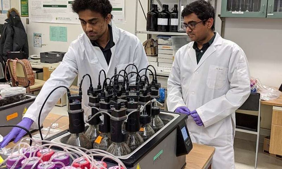 Environmental engineering master&apos;s student Bappi Chowdhury (left) and supervisor Bipro Dhar in the lab with a &apos;digester&apos; they are developing that uses microbes to convert a mixture of food waste and fat, oil and grease into renewable biomethane.