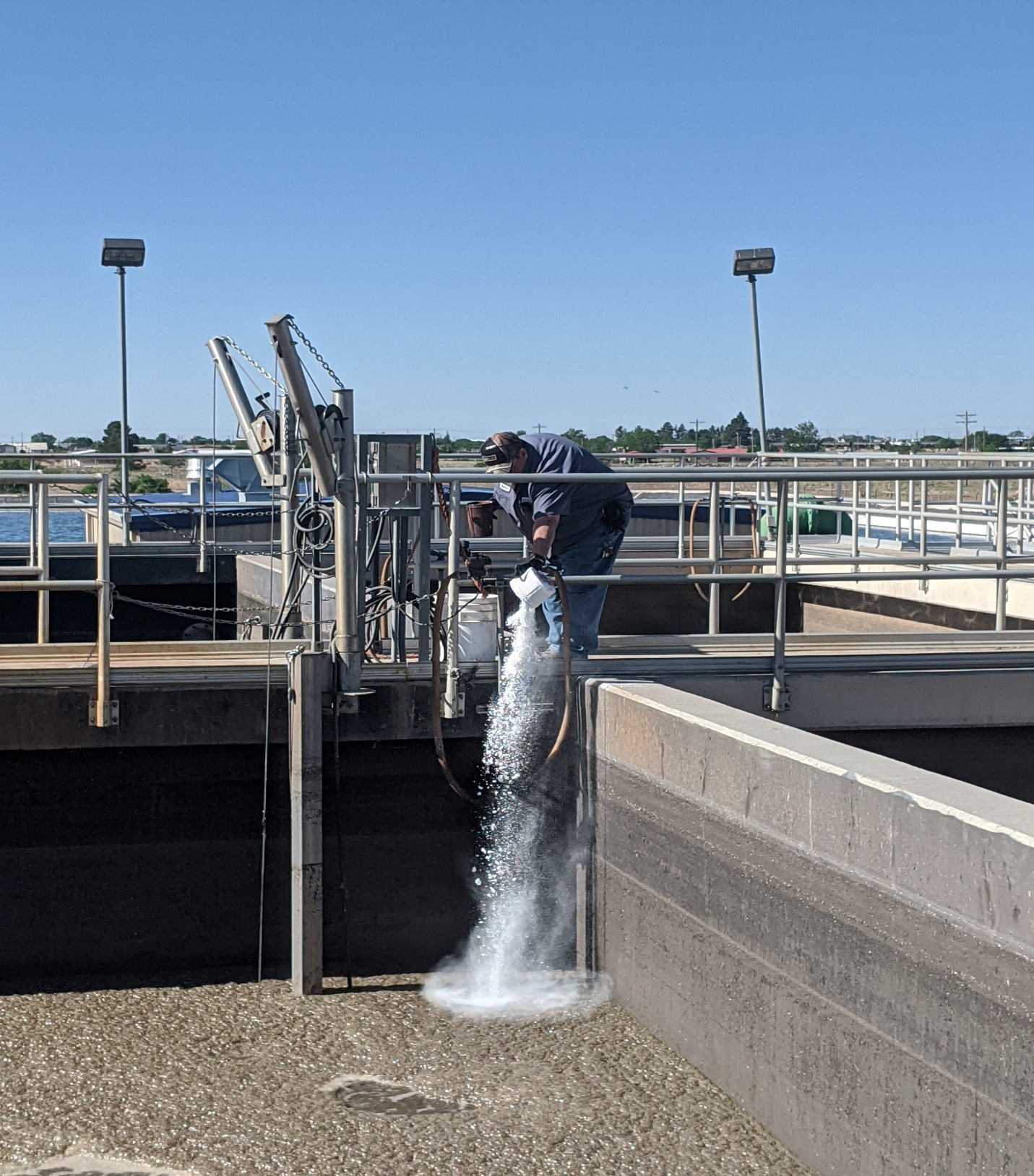 City of Lovington WWTP Superintendent Miguel De La Cruz doses AT-318 into an SBR tank.