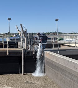 City of Lovington WWTP Superintendent Miguel De La Cruz doses AT-318 into an SBR tank. City of Lovington WWTP Superintendent Miguel De La Cruz doses AT-318 into an SBR tank.