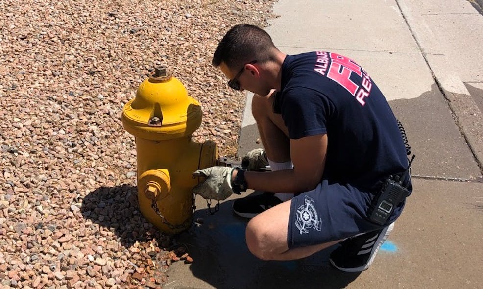 Albuquerque Fire and Rescue staff inspecting a fire hydrant.