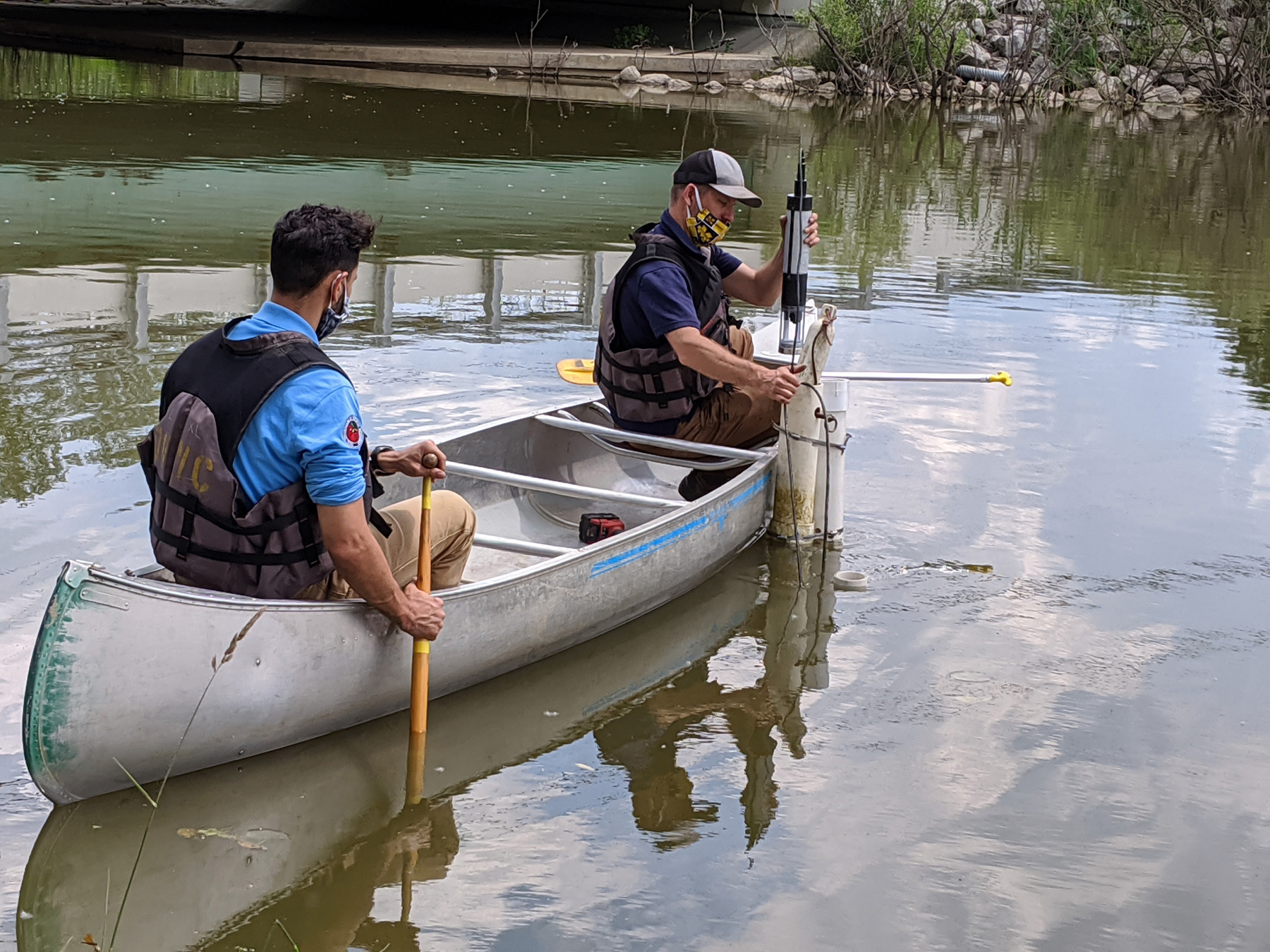 LimnoTech's Ed Verhamme carefully deploys the water quality sensor while an ODNR staff member steadies the canoe. This device is installed alongside a much more expensive unit to enable direct performance comparison and will stream data to the internet in real-time thanks to the newly installed LoRa radio gateway.
