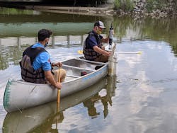 LimnoTech's Ed Verhamme carefully deploys the water quality sensor while an ODNR staff member steadies the canoe. This device is installed alongside a much more expensive unit to enable direct performance comparison and will stream data to the internet in real-time thanks to the newly installed LoRa radio gateway. LimnoTech's Ed Verhamme carefully deploys the water quality sensor while an ODNR staff member steadies the canoe. This device is installed alongside a much more expensive unit to enable direct performance comparison and will stream data to the internet in real-time thanks to the newly installed LoRa radio gateway.