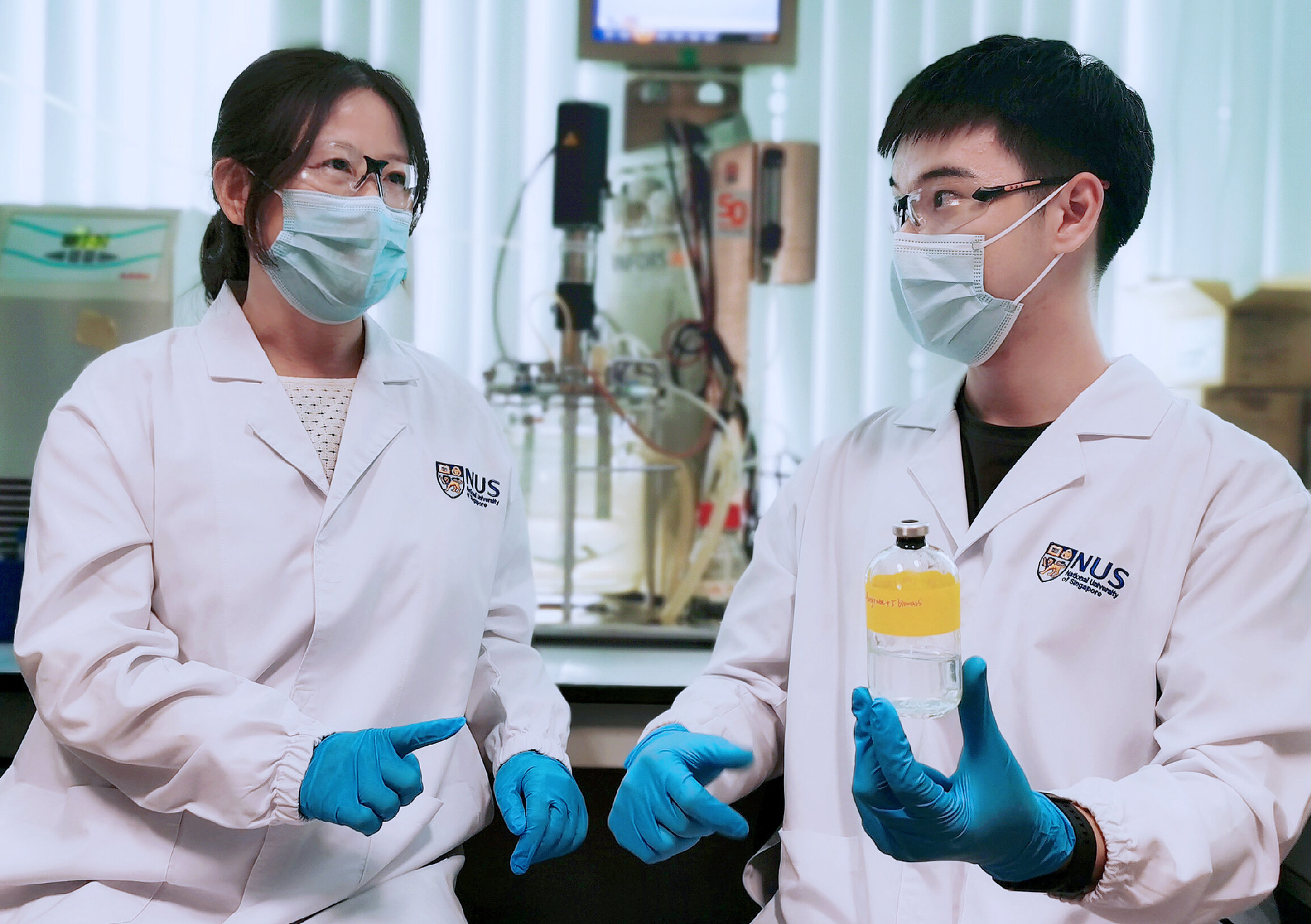The team led by Associate Professor He Jianzhong (left) and Research Fellow Dr Wang Qingkun (right) discovered Thauera sp. strain SND5 after they isolated and tested various strains of bacteria from wastewater samples. Dr Wang holding a wastewater sample containing the unique SND5 bacterium.