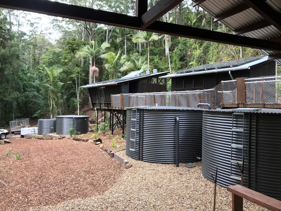 Treated effluent from the AdvanTex&circledR; AX-MaxTM system is clean enough to be reused as subsurface irrigation. Left to right, the storage tanks at this off-grid camp contain treated AdvanTex effluent, rainwater for fighting bushfires, and rainwater that will be treated and used as potable water.