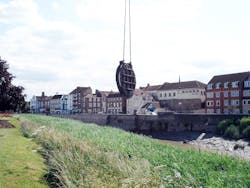 A crane removes the malfunctioning flapgate valve. A crane removes the malfunctioning flapgate valve.