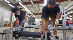 Graduate students Abhimanyu Das (left) and Akshay Rao adjust a piston tank, the key component to a new desalination process called “double-acting batch reverse osmosis.”