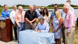 Governor John Carney signing the Clean Water for Delaware Act at a public event on July 22.