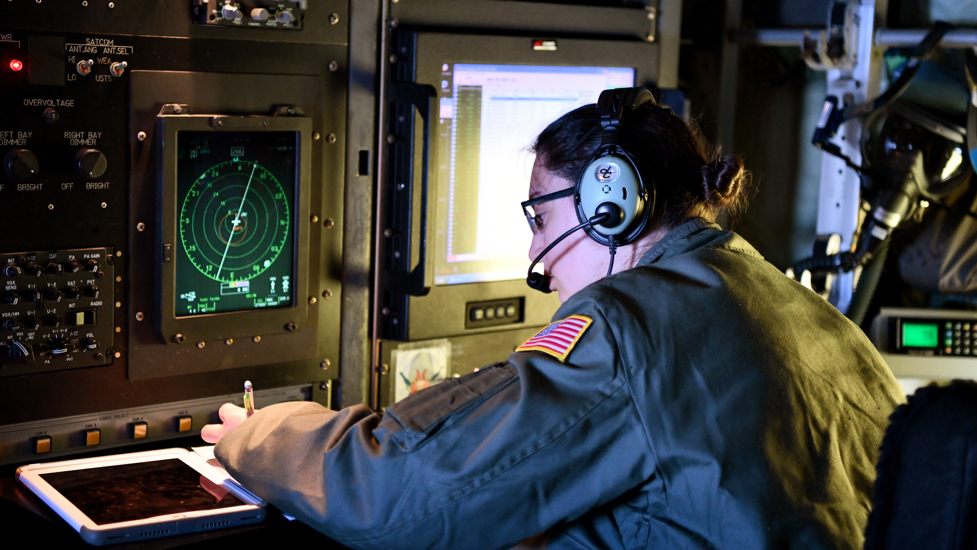 Maj. Sonia Walker, aerial weather reconnaissance officer for the 53rd Weather Reconnaissance Squadron at Keesler Air Force Base, Miss., writes down coordinates after a dropsonde deployment during a flight from Reno-Tahoe International Airport, Nev., Jan. 31, 2021. As an ARWO, Walker oversees the data collection from dropsondes to make sure they are accurate before sending that data to forecasters and researchers.