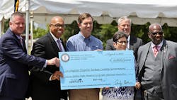 Kentucky governor Andy Bechear alongside Lexington mayor Linda Gordon and other officials with the $11.8M dollar check.