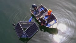 A closer look at LG Sonic's MPC-Buoy with a boat of workers nearby. A closer look at LG Sonic's MPC-Buoy with a boat of workers nearby.
