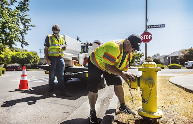 Workers install a smart hydrant equipped with multiple sensors in San Jose, Calif.
