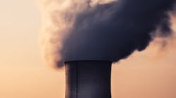 A cooling tower's fumes of a nuclear power plant in France. A cooling tower's fumes of a nuclear power plant in France.