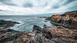 A view of the blue Pacific Ocean crashing into rocks at the glass beach in Fort Bragg, California. A view of the blue Pacific Ocean crashing into rocks at the glass beach in Fort Bragg, California.
