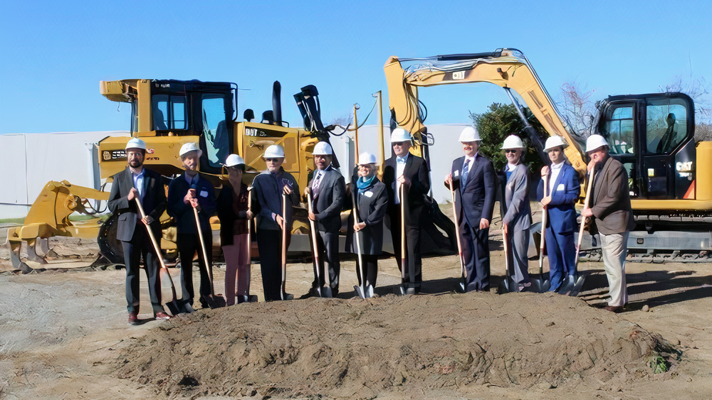 A group of dignitaries ceremonially turned over shovels-full of dirt to commemorate the groundbreaking.