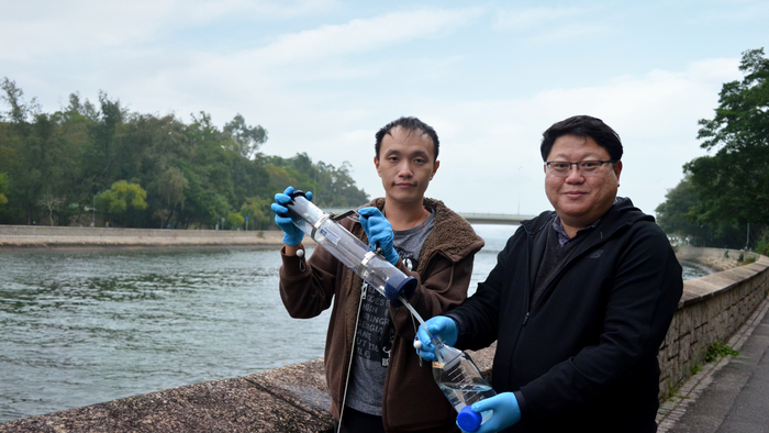 Professor Kenneth Leung (right) and his postdoc Dr Racliffe Lai (left) take a sample from the Lam Tsuen River in Hong Kong.