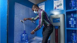 A customer fills up a large bottle with potable drinking water at a Diam'O franchise kiosk in Dakar. A customer fills up a large bottle with potable drinking water at a Diam'O franchise kiosk in Dakar.