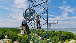 Workers install a new telecommunications gateway at the University of Toledo&rsquo;s Lake Erie Center