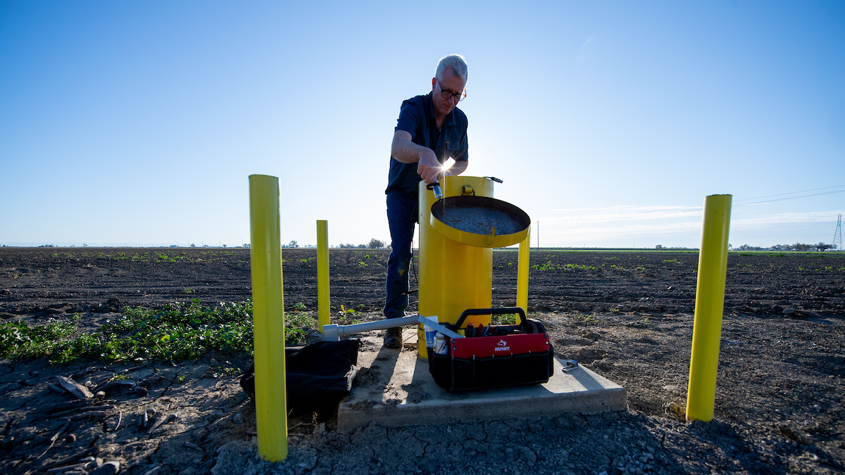 A DWR engineering geologist measures groundwater levels at designated monitoring wells in Yolo County.