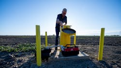 A DWR engineering geologist measures groundwater levels at designated monitoring wells in Yolo County.