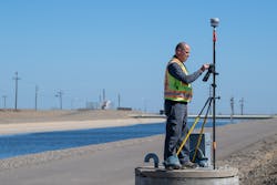 Operators use tripod-mounted surveyor equipment to survey the California Aqueduct embankment near the San Luis Reservoir in Merced County. Historically, DWR has conducted traditional ground surveys to track subsidence rates and magnitudes.