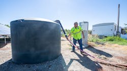 Water is delivered to fill a 1500 gallon potable water tank at a property in Glenn County, where wells have run dry.