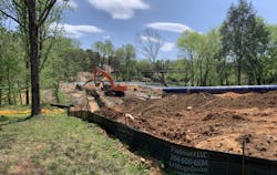 Excavators prepare for the installation of piping across the Rocky River. Excavators prepare for the installation of piping across the Rocky River.