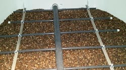 Fig. 3: Horizontal pressure filter shown with new graded gravels and air scour grid, prior to placement of filter media. Fig. 3: Horizontal pressure filter shown with new graded gravels and air scour grid, prior to placement of filter media.