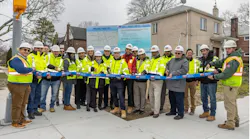 DDC Commissioner Thomas Foley (center), the DDC project team, consultants and contractors celebrate the completion of the $79.7 million project that rebuilt 3.5 miles of streets along 33rd, 37th and 38th Avenues.