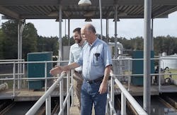 John Neilson and Geordan Stroud, application engineer with MIEX, survey the flocculation tank, where the pretreatment process allows the district to high rate their existing flocculation and sedimentation process, resulting in longer membrane run time and fewer cleanings. John Neilson and Geordan Stroud, application engineer with MIEX, survey the flocculation tank, where the pretreatment process allows the district to high rate their existing flocculation and sedimentation process, resulting in longer membrane run time and fewer cleanings.