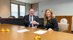 Egg Harbor City Mayor Lisa Jiampetti (right) signs agreement to sell its water and wastewater system to New Jersey American Water.