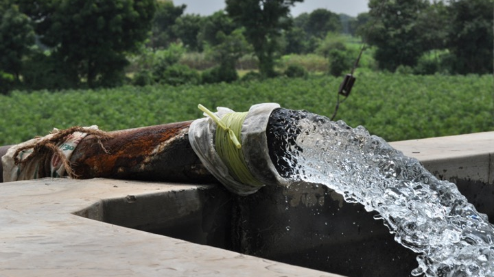 A bore well pumping groundwater to irrigate fields in Gujarat, India. Wells in this region can pull groundwater from up to 800 feet below ground, and water tables are falling rapidly due to overexploitation.