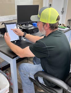 Operator entering data on a mobile device. Operator entering data on a mobile device.