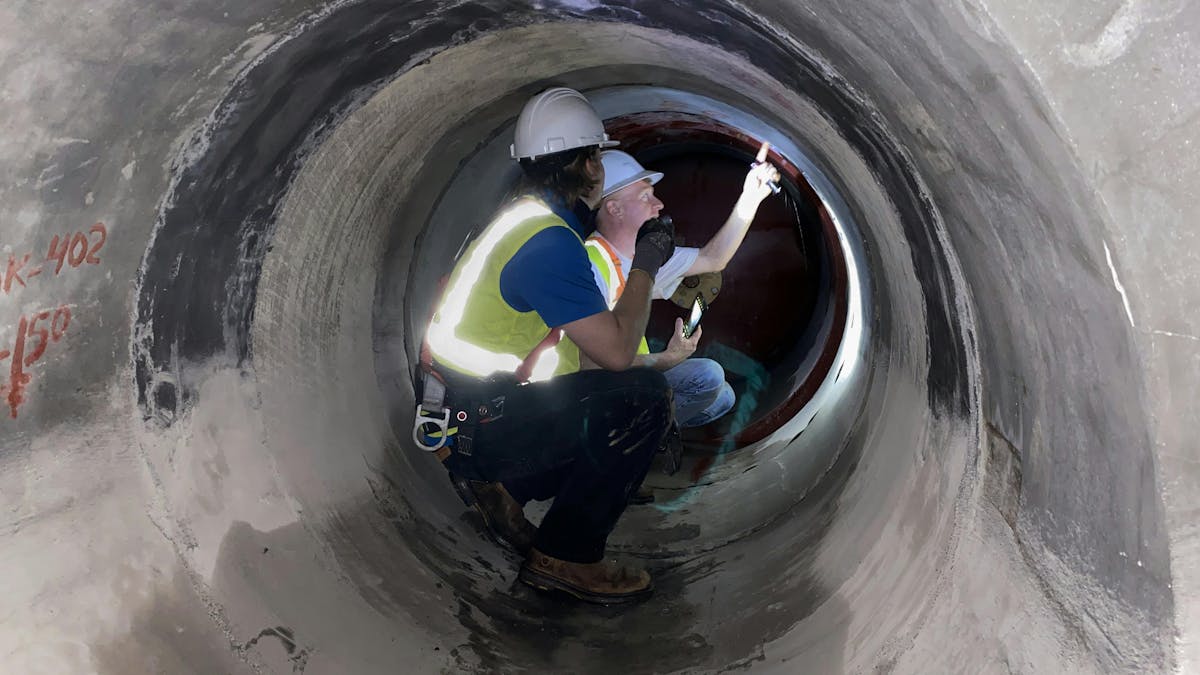 Benjamin McCray and Greg Henry assess an interconnect between the North 60 line and a new 72-in project.