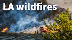 Two Firefighters Stand Next to Bulldozer with Hillside Burning in Background during California Fire. Two Firefighters Stand Next to Bulldozer with Hillside Burning in Background during California Fire.