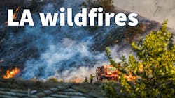Two Firefighters Stand Next to Bulldozer with Hillside Burning in Background during California Fire. Two Firefighters Stand Next to Bulldozer with Hillside Burning in Background during California Fire.