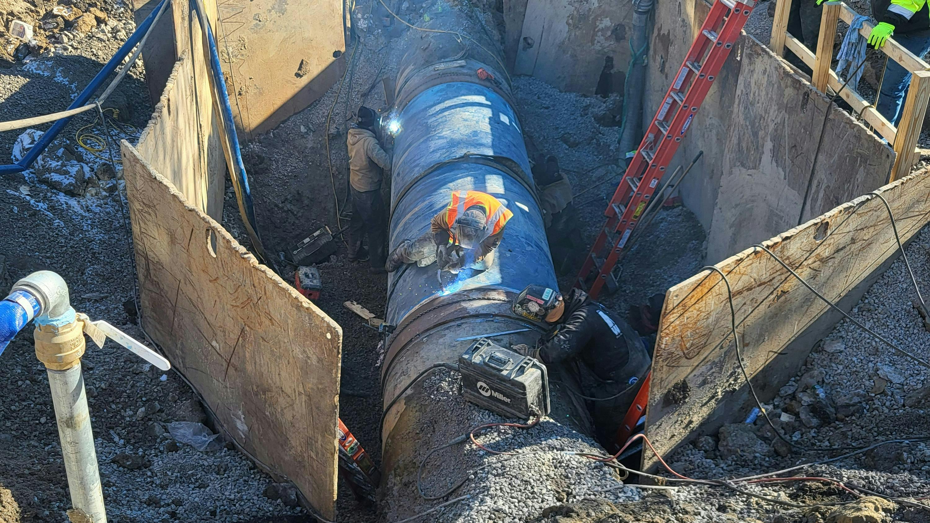 New pipe being welded into place.