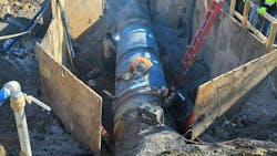 New pipe being welded into place. New pipe being welded into place.