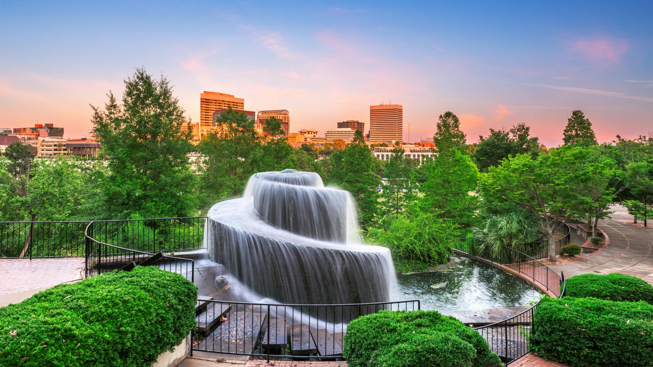 Columbia, South Carolina, USA downtown skyline and park at dusk