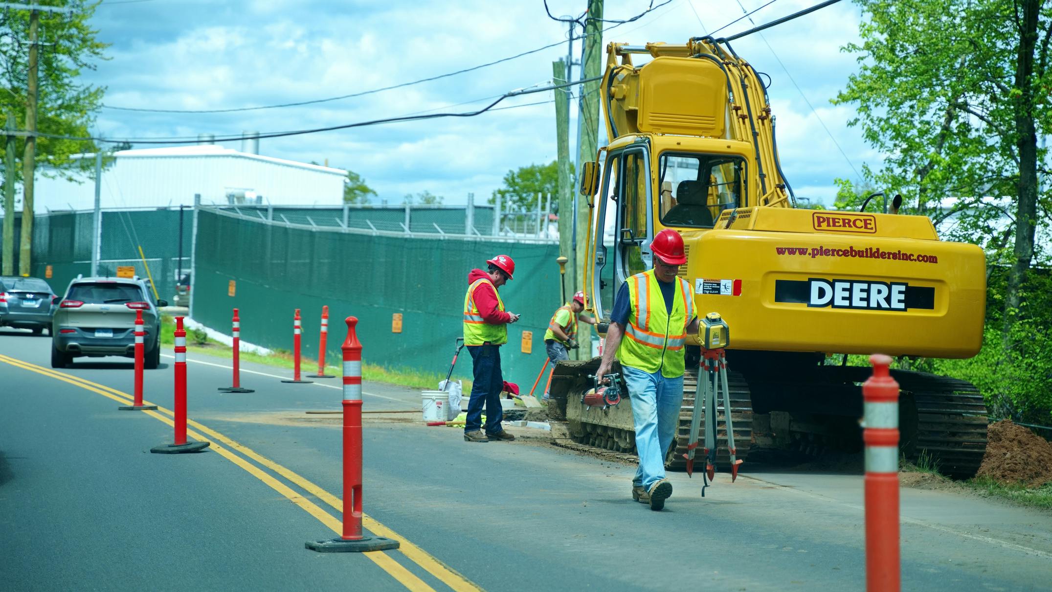 Public utilities workers digging and surveying