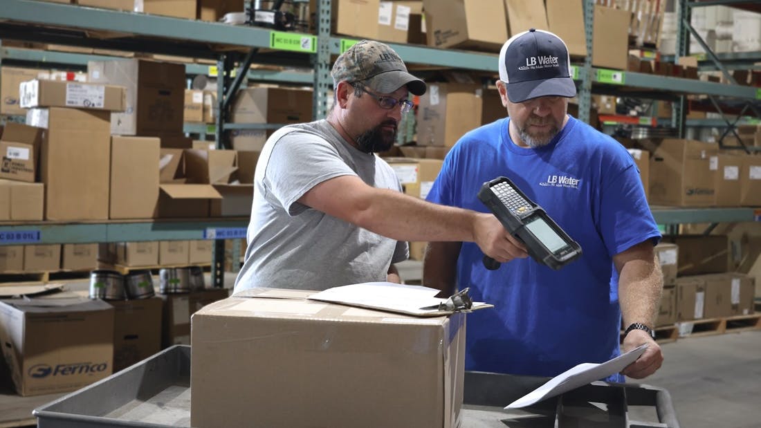 An LB Water employee uses a handheld RF computer for faster order fulfillment. After deploying their new WMS, LB Water&rsquo;s Stoneboro warehouse saw significant efficiency gains.