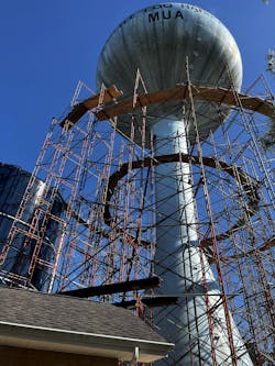 Figure 2: A protective containment structure was set up around the tower to protect surrounding areas from restoration activities, with the added benefit of keeping the secret design under wraps (Photo credit: Courtesy of Little Egg Harbor MUA). Figure 2: A protective containment structure was set up around the tower to protect surrounding areas from restoration activities, with the added benefit of keeping the secret design under wraps (Photo credit: Courtesy of Little Egg Harbor MUA).
